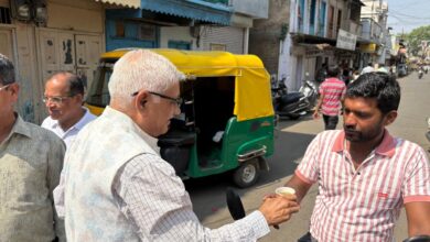 Dr. Pramod Jain distributing sugarcane juice to a passerby on Akshaya Tritiya in Dewas